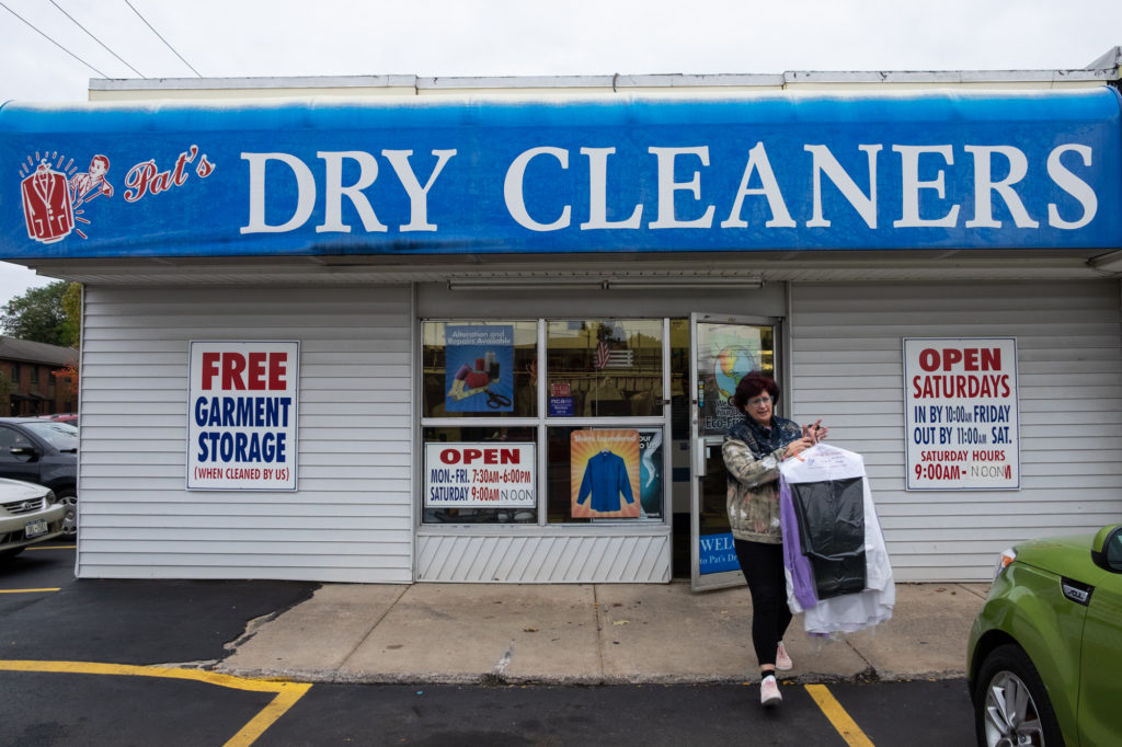 Woman in front of dry cleaners