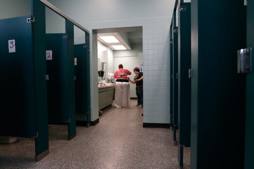 women getting ready in a public restroom