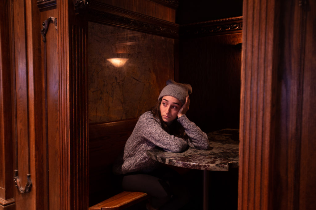 girl sitting in a booth