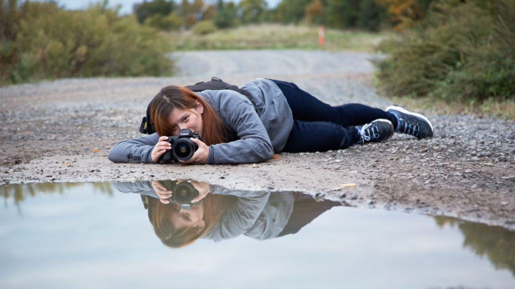 girl taking photo from the ground